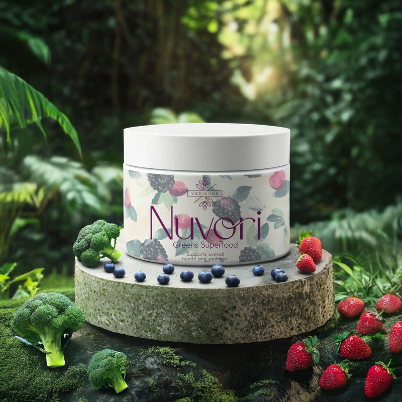 A container of Nuvori greens superfood powder, surrounded by an array of fruits and vegetables including broccoli and strawberries, set against a forest-like background.